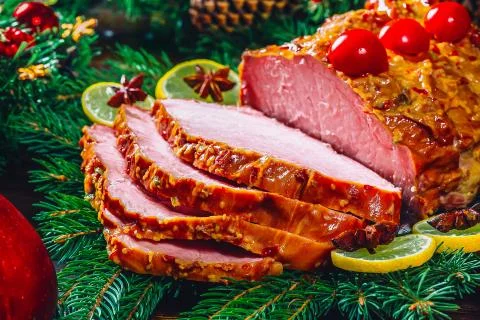 Christmas table dinner time with roasted meats, candles and New Year dcor. Ba Stock Photos