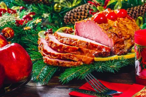 Christmas table dinner time with roasted meats, candles and New Year dcor. Ba Stock Photos