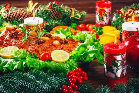 Christmas table dinner time with roasted meats decorated in Christmas style.  Stock Photos