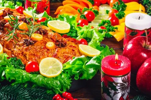 Christmas table dinner time with roasted meats decorated in Christmas style.  Stock Photos