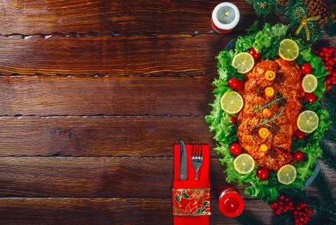 Christmas table dinner time with roasted meats decorated in Christmas style w Stock Photos