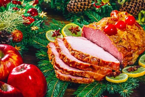 Christmas table dinner time with roasted meats, candles and New Year dcor. Ba Stock Photos