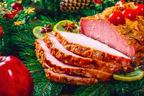 Christmas table dinner time with roasted meats, candles and New Year dcor. Ba Stock Photos