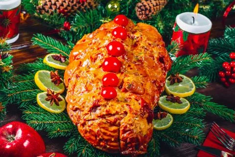 Christmas table dinner time with roasted meats, candles and New Year dcor. Ba Stock Photos