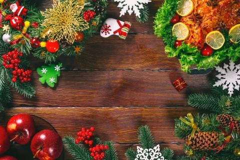 Christmas table dinner time with roasted meats decorated in Christmas style.  Stock Photos