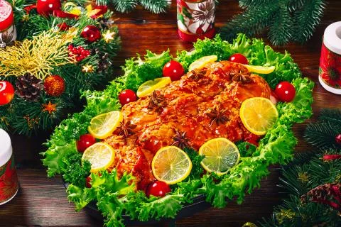 Christmas table dinner time with roasted meats decorated in Christmas style.  Stock Photos
