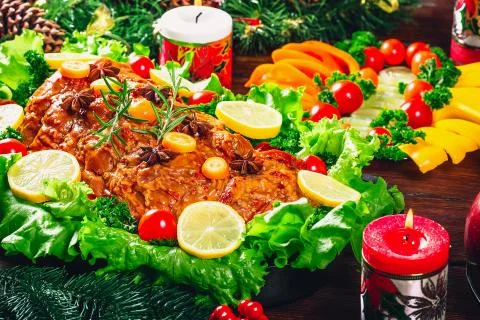 Christmas table dinner time with roasted meats decorated in Christmas style.  Stock Photos