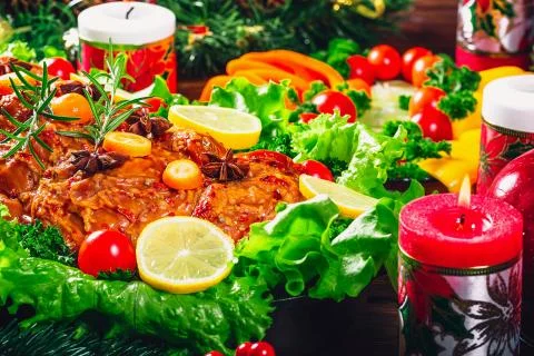 Christmas table dinner time with roasted meats decorated in Christmas style.  Stock Photos