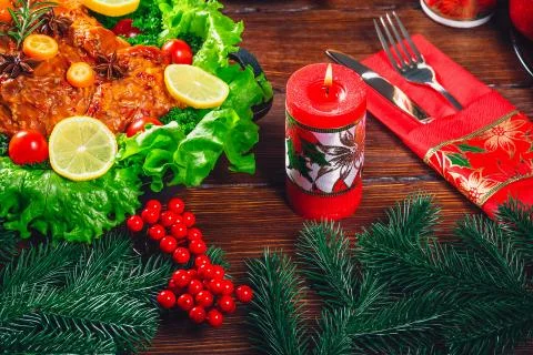 Christmas table dinner time with roasted meats decorated in Christmas style.  Stock Photos