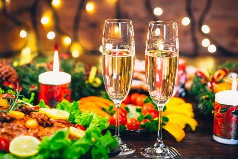 Christmas table dinner time with roasted meats decorated in Christmas style w Stock Photos