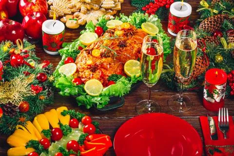 Christmas table dinner time with roasted meats decorated in Christmas style w Stock Photos