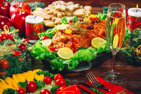 Christmas table dinner time with roasted meats decorated in Christmas style w Stock Photos