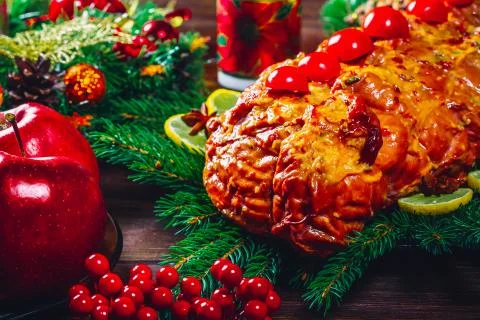 Christmas table dinner time with roasted meats, candles and New Year decor. B Stock Photos