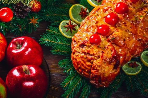 Christmas table dinner time with roasted meats, candles and New Year decor. B Stock Photos