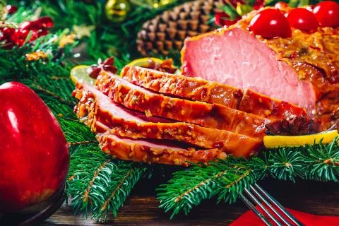 Christmas table dinner time with roasted meats, candles and New Year decor. B Stock Photos