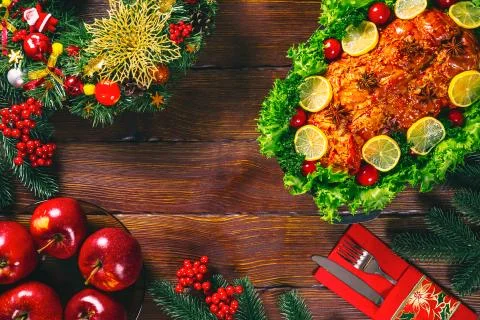 Christmas table dinner time with roasted meats decorated in Christmas style.  Stock Photos