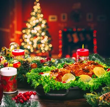 Christmas table dinner time with roasted meats decorated in New Year style on Stock Photos