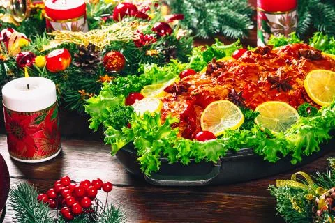 Christmas table dinner time with roasted meats decorated in Christmas style.  Stock Photos