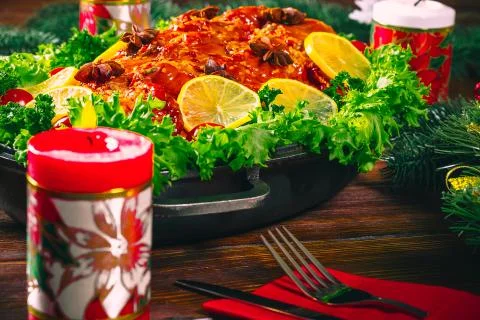 Christmas table dinner time with roasted meats decorated in Christmas style.  Stock Photos