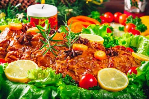 Christmas table dinner time with roasted meats, candles and New Year dcor. Ba Stock Photos