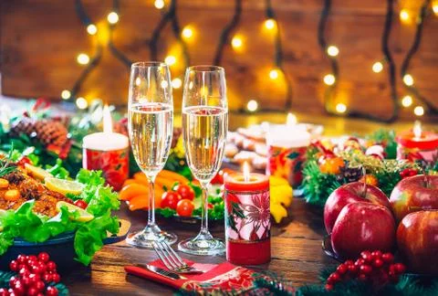 Christmas table dinner time with roasted meats decorated in Christmas style w Stock Photos