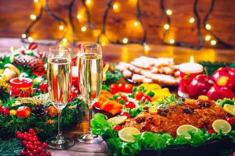 Christmas table dinner time with roasted meats decorated in Christmas style w Stock Photos