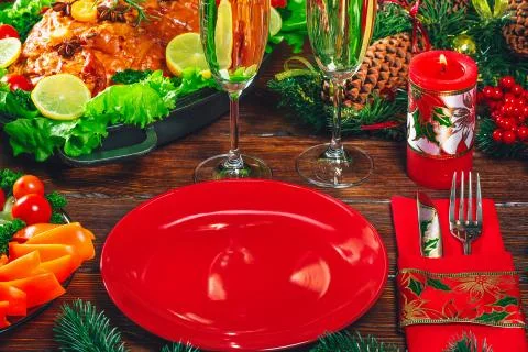 Christmas table dinner time with roasted meats, candles and New Year dcor. Ba Stock Photos