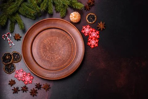 Christmas table with empty plate and surface with New Year's decorations Stock Photos