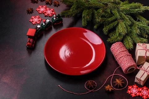 Christmas table with empty plate and surface with New Year's decorations Stock Photos