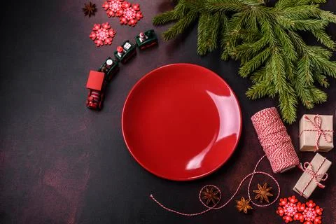 Christmas table with empty plate and surface with New Year's decorations Stock Photos