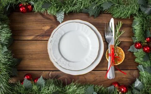 Christmas table layout, red tape with a cinnamon stick, rosmarin and a slice of Stock Photos