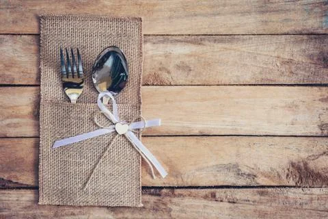 Christmas table place setting and silverware on wood with space. Stock Photos