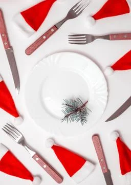 Christmas table place setting with empty white plate, linen napkin, cutlery Stock Photos