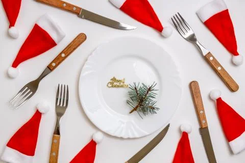 Christmas table place setting with empty white plate, linen napkin, cutlery Stock Photos