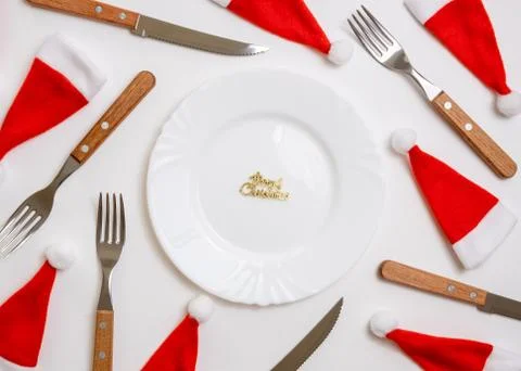 Christmas table place setting with empty white plate, linen napkin, cutlery Stock Photos