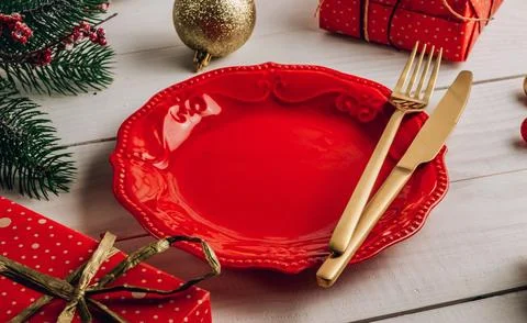 Christmas table place setting with empty plate and cutlery on white wooden .. Stock Photos