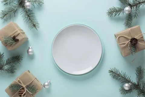 Christmas table setting and festive decor on a light blue background with fir Stock Photos