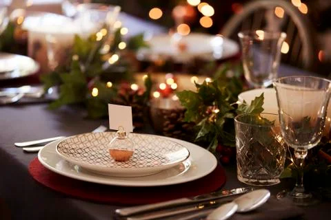 Christmas table setting with bauble name card holder arranged on a plate and Stock Photos