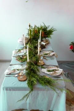 Christmas table setting with branches and candles, winter breakfast or dinner Stock Photos