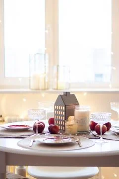Christmas table setting with burning candles, retro lights and champagne gl.. Stock Photos