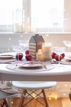 Christmas table setting with burning candles, retro lights and champagne glas Stock Photos