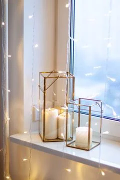 Christmas table setting with burning candles, retro lights and champagne glas Stock Photos