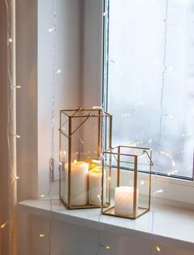 Christmas table setting with burning candles, retro lights and champagne glas Stock Photos