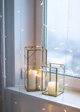 Christmas table setting with burning candles, retro lights and champagne glas Stock Photos