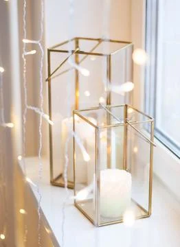 Christmas table setting with burning candles, retro lights and champagne glas Stock Photos