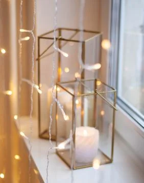 Christmas table setting with burning candles, retro lights and champagne glas Stock Photos