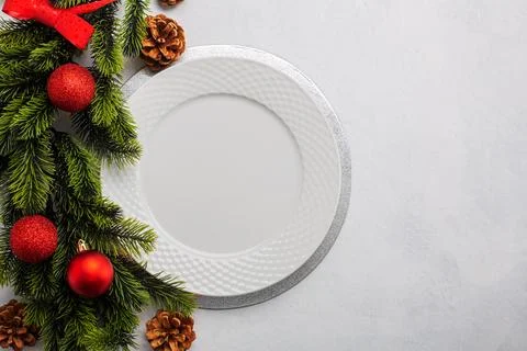 Christmas table setting consisting of a empty white plate. Top view with co.. Stock Photos