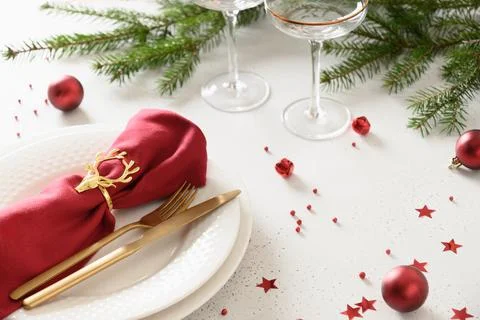 Christmas table setting with elegant red decorations on white table. Stock Photos