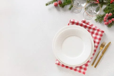 Christmas table setting with elegant red decorations on white table. View f.. Stock Photos