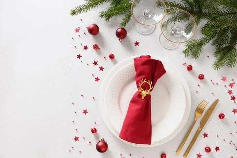 Christmas table setting with elegant red decorations on white table. Stock Photos